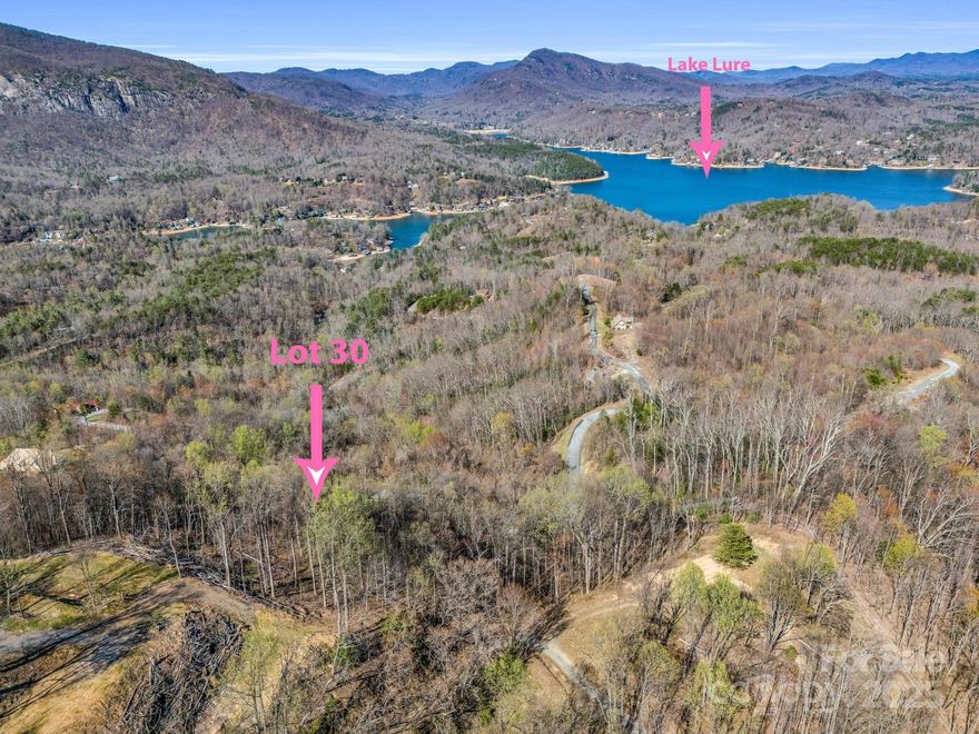 An extraordinary homesite is available in the prestigious Highlands of Lake Lure gated community. This meticulously previously cleared lot features a "pre-cut driveway" and offers unparalleled, sweeping views! Imagine watching the sun set over the glistening lake and the majestic mountains on the horizon, while the distant mountain communities come alive with twinkling lights against the night sky. This property is designed for those who seek awe-inspiring mountain vistas without compromising on accessibility. Just a short drive away from grocery stores, the Lake Lure area, the tryon International Equestrian Center and more! Reach out to arrange a personal viewing (*gated) and marvel at the captivating mountain views and the beauty of Lake Lure that people come from all over to see!