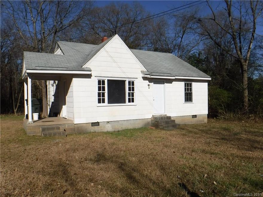 2 lots transfer with this site. Neat little bungalow with almost 1 Acre - .9 +/- AC. Actual age of home unknown.