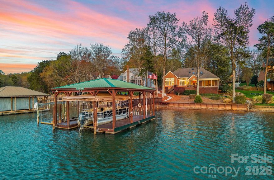 Welcome to 124 Hunter Spring, a rare opportunity to own an all-brick ranch floorplan in the highly sought-after community of The Harbour at the Pointe. Nestled on a quiet cul-de-sac, this single-level waterfront home offers over 2,500 SF of thoughtfully designed living space with stunning Lake Norman views. Inside, you’ll find 3 spacious bedrooms, 2 full bathrooms, a powder room, dining room and private office, perfect for working from home. The open-concept layout features a great room seamlessly connected to the kitchen and breakfast area, along with a stunning living room for added flexibility. Vaulted ceilings, detailed crown molding, tray ceilings, and fresh neutral paint throughout create a bright, elegant atmosphere. A dual sided cozy fireplace can be enjoyed from the breakfast area room or Living room.The primary suite is a true retreat, showcasing expansive floor-to-ceiling windows that capture breathtaking lake views. Step outside to a screened porch and deck overlooking a beautiful, wide cove—ideal for relaxing or entertaining. For lake lovers, the private covered dock is a standout feature, complete with a boat lift and motorized boat cover, making it easy to enjoy everything Lake Norman has to offer. This low maintenance home offers plenty of storage opportunities with walk-in closets, attic space and an tall unfinished crawlspace/workshop. Don’t miss this rare combination of ranch-style living, prime waterfront location, and top tier community amenities all in one exceptional property.