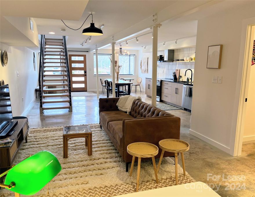 Pristine sun filled modern loft at the downtown Tryon Train Depot - can’t beat the location and amenities in this beautiful spot.  Walkable to all downtown restaurants, shopping, movie theater, weekend festivals.  One large bedroom with a king bed is upstairs, with a deck looking out over Trade Street and the mountains beyond.  Large bath, walk in closet and washer dryer in the main suite.  Main level is a beautiful open space with fabulous kitchen, living, dining, den and a half bath for guests.  Available on a flex term lease - fully furnished at $2,500 per month. Utilities and high speed internet included.  Please text or call agent for details.