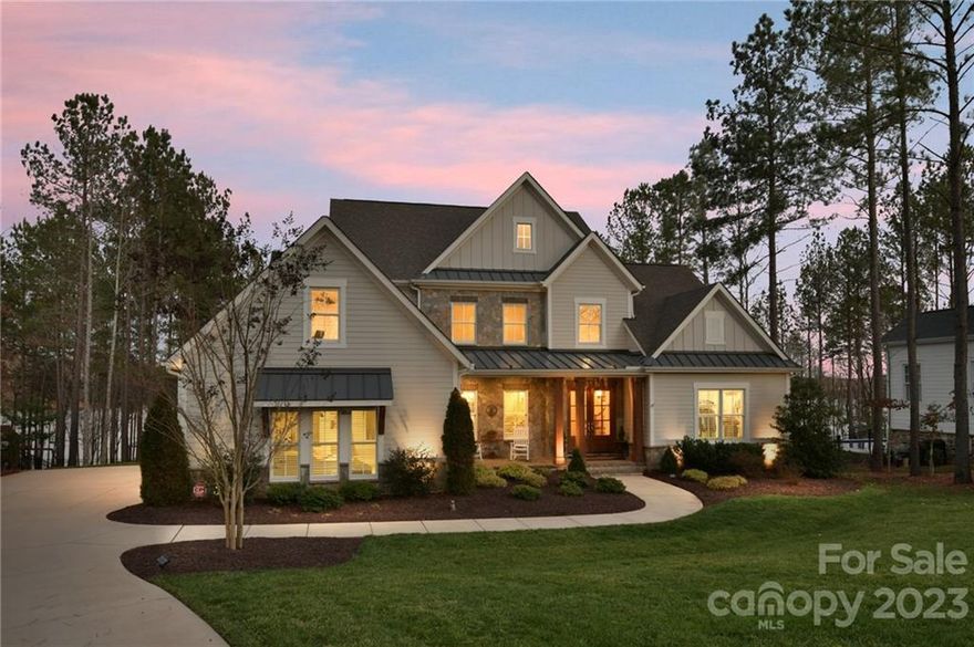 Live the Dream in this beautiful custom waterfront home. This farmhouse style home has an open floor plan. You can see the lake as you enter the house through the double mahogany front doors looking through the great room through the triple sliding glass doors. The great room opens onto large screened porch with gas fireplace and outdoor kitchen.  Imagine waking up to beautiful sunrises over the lake. On the main floor the breakfast room, great room, office and primary bedroom overlook the lake. Chefs kitchen with large island and quartz countertops. A curved wet bar with beverage refrigerator and wine closet make this home great for entertaining. The second floor boasts 3 ensuite bedrooms, a flex room/5th bedrm currently being used as an exercise room, vaulted bonus room with a 2nd wet bar and beverage refrigerator.  There is heated and cooled walk in storage, not included in HLA. Room for a pool. Agent Owned. Close to Airport and all Belmont has to offer.  Please see the video tour.