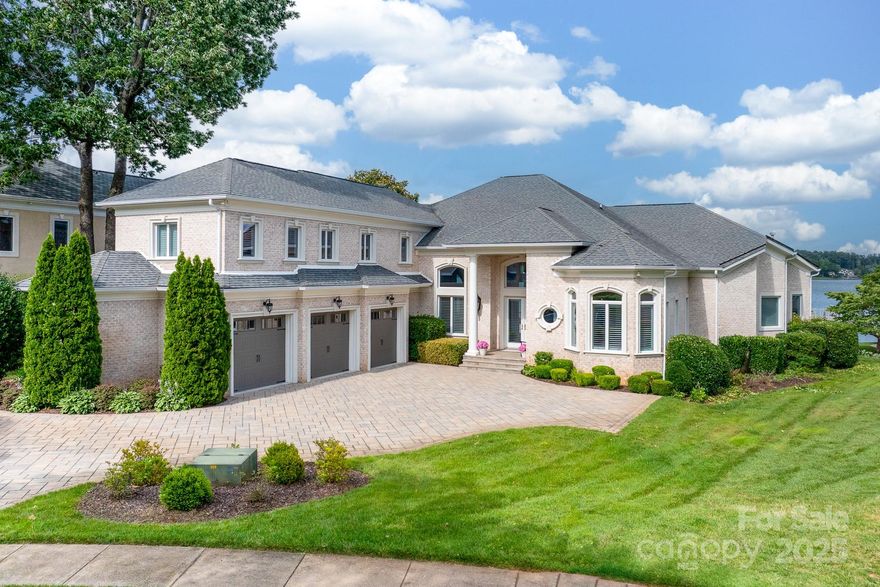 Situated in the coveted, gated enclave of Governors Island—Lake Norman’s premier private island—this exquisite waterfront residence offers a masterfully updated interior & breathtaking, unobstructed lake views. Notable enhancements include a paver driveway, new HVACs, encapsulated crawlspace, and whole-home WiFi + surround sound. The reimagined floor plan opens to expansive lake vistas through dramatic fold-away glass doors, merging elegant indoor living with the travertine-clad terrace, outdoor kitchen, and resurfaced pool. The show-stopping primary ensuite features floor-to-ceiling tile, LED ambient lighting, and a custom Denver Closets wardrobe. The dock has been rebuilt from the seawall out and includes heavy-duty boat & PWC lifts. With soaring ceilings, refined millwork, a chef’s kitchen, and a spacious split-bedroom layout, this timeless retreat delivers luxurious lakeside living in one of Lake Norman’s most exclusive communities.