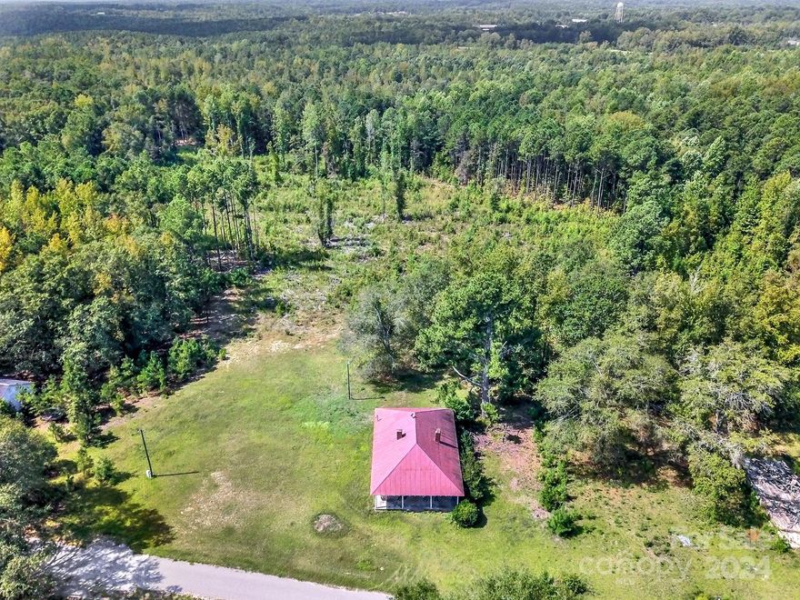 Country living at its finest! Just shy of 8 acres get ready to build your dream home OR renovate the current structure on the lot! . Welcome home to this 1930's 3 bedroom farm style home. Enjoy the breeze while sitting on the front porch. Hardwood floors in great shape! Multiple fireplaces throughout. Third bedroom can also be used as a bonus space. Septic tank is on property but has not been serviced in years and seller makes no claim to its functionality. Water is available, seller couldn't remember if it was city or county. With some updating this could be an amazing place to call home. 36 miles to Rock Hill, 12 miles to Lancaster, and just 55 miles to Uptown Charlotte. Property is not in city limit.