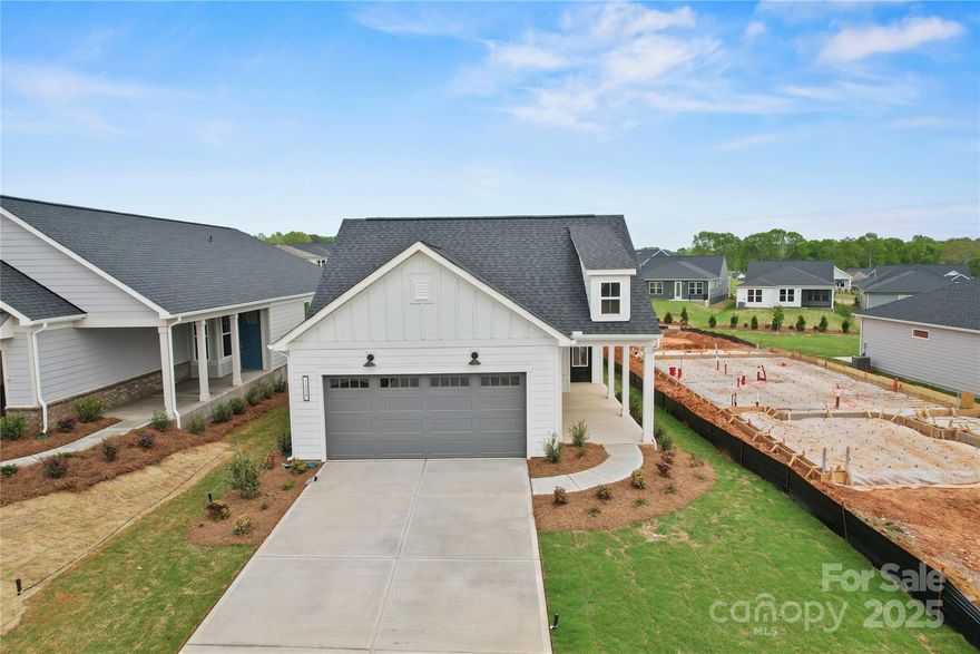Welcome to the newest premier 55+, active-adult community in the Charlotte area: Carolina Riverside! 
Conveniently located to charming downtown Belmont, Charlotte-Douglas International Airport, the Catawba River and Lake Wylie, hospitals, grocery stores, golf courses, and more. Enjoy HOA-included lawn maintenance, TV & high-speed Internet, a lifestyle director, and a multitude of amenities in the works including a 19K square foot clubhouse, indoor and outdoor pools, pickleball and bocce courts, walking trails, and dog park. This move-in-ready Compass home boasts an open-concept main level with a flex room, airy sunroom, luxe owner's suite, and a guest bedroom! Several high-end finishes including a deluxe kitchen with gas range. Please contact us to schedule a visit!