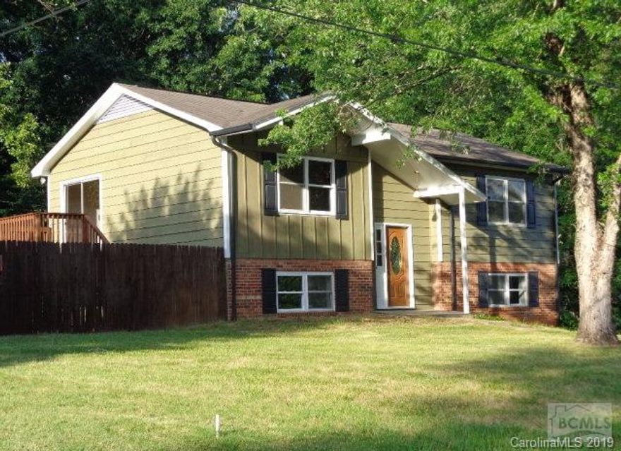 Wow! A Beautiful home that has been renovated inside and out. Step through the new front door and step up to the open concept living area that hosts a large living room, a kitchen with new cabinets and new appliances. Through a large glass from the dining area you can step out on a great deck that is large enough for a lounging and dining. The soft colors and beautiful hardwood floors on this floor are stunning. Step down the hall to a large bathroom with new fixtures, ceramic floors and a new granite topped double vanity.  Further down the hall are three full sized bedrooms. The downstairs area is just as impressive. Enjoy a large Family/Recreation Room that spans from the front to the back of the home. This room also opens up to a patio. This floor has a second full bathroom and a fourth bedroom. Finishing off this floor is a final space that could be a fifth bedroom, but is perfect for a home office or craft/ work area as it also has an exterior entrance. It would also make a great