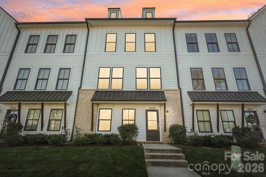 Stunning South Charlotte townhome in the heart of Ballantyne with a rooftop terrace, bonus room, and two-car garage!

This beautifully designed home features an open-concept main living area filled with natural light and a seamless flow on each level going up to the private balcony, perfect for everyday living and entertaining. The kitchen is stunning, offering a large eat-in island, walk-in pantry, shaker-style light gray cabinetry, tile backsplash, stainless steel appliances, and polished quartz countertops.

Elegant 5-inch hardwood floors run throughout the main living spaces, complemented by tile flooring in the bathrooms and thoughtfully selected finishes throughout the home.

Upstairs, each bedroom offers its own full bathroom and walk-in closet, including a spacious primary suite with dual walk-in closets. A conveniently located laundry area adds to the home’s functional layout.

The top level features a versatile bonus room that opens to an incredible rooftop terrace, ideal for entertaining, relaxing, or enjoying treetop views and beautiful Carolina skies.

Additional highlights include a two-car garage with EV charger ready, smart home features, and included lawn maintenance for easy living.

Perfectly situated just minutes from shopping, dining, and entertainment at Ballantyne Bowl and Stonecrest, with quick access to I-485.