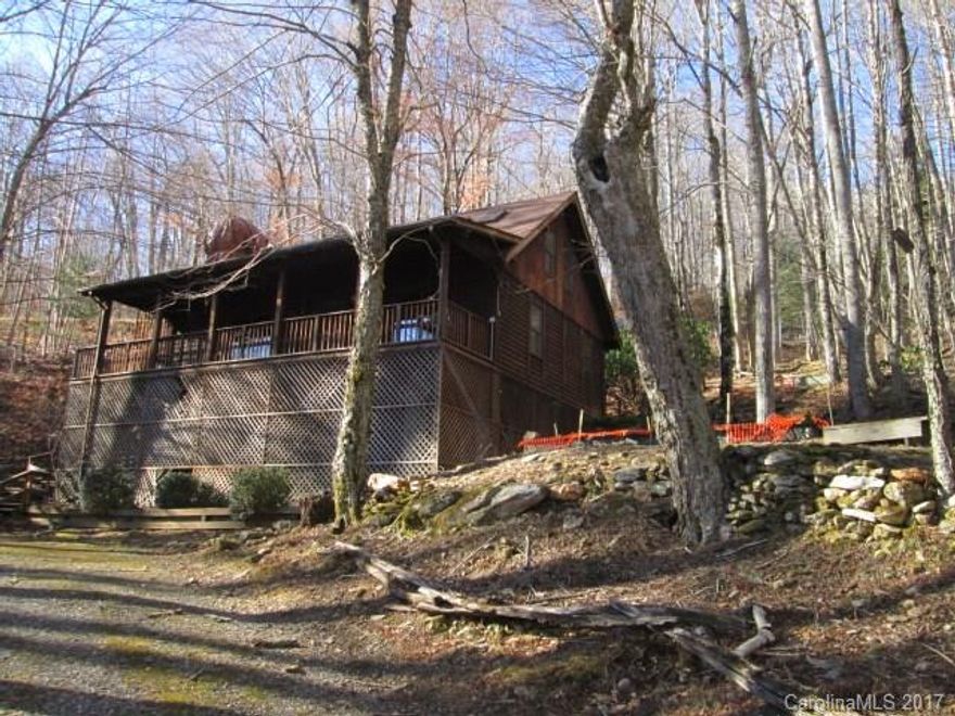 Cabin in the woods! Located in Wolf Laurel gated community. Features 2BR/2.5BA, circular driveway, loftspace with closet,wood floors,breakfast bar, pantry, open floorplan with fireplace, covered front porch, rear patio/deck. Located beside a stream and small pond in side yard. Community amenities are golf, tennis, skiing, outdoor pool, fishing pond and community center. Homepath Ready Buyer Program available. HomeReady Mortgage may apply.