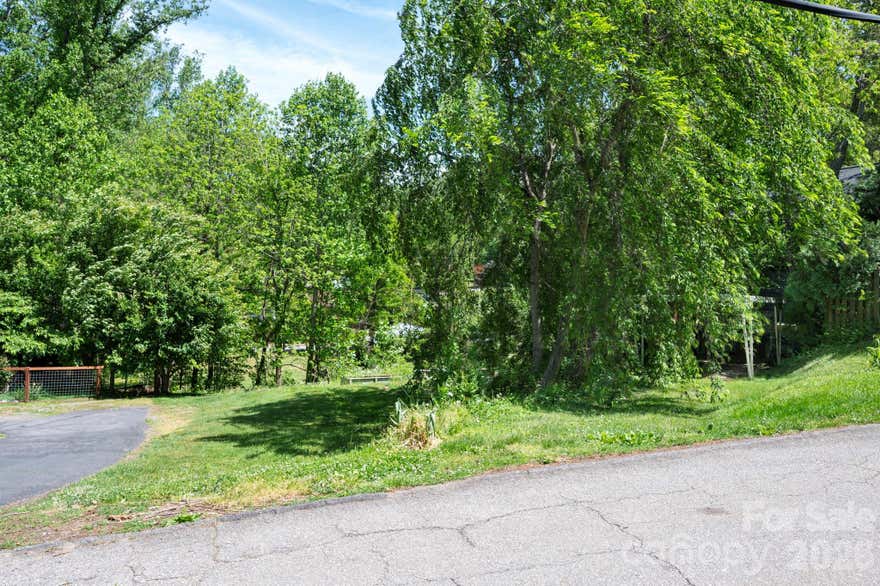 A rare chance to secure land in the core of West Asheville, just minutes from Haywood Road—one of the city’s most dynamic and desirable areas. Whether you’re envisioning a custom home or exploring a strategic build project, this property delivers on location, character, and long-term value. Set among mature trees with a sense of privacy, yet close to the energy of shops, dining, and entertainment, the lot offers the balance today’s buyers are actively seeking. Build new, build smart, and position yourself in a neighborhood that continues to outperform.