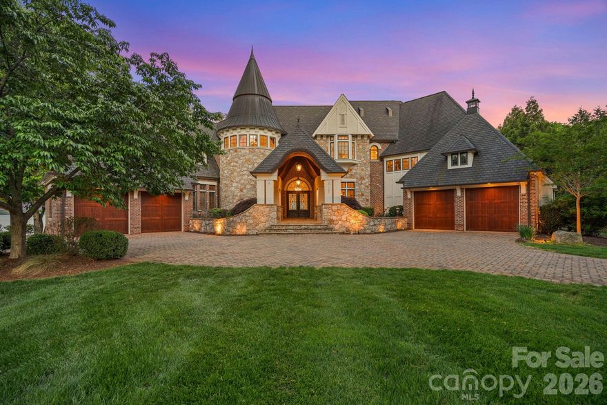 Set on approximately 1.48 private acres with approximately 450 feet of open, deep-water shoreline, 109 Conway Court is a rare waterfront estate located on one of The Point’s most coveted addresses. This architecturally significant residence offers an extraordinary combination of scale, craftsmanship, and lakefront living.
A dramatic arrival begins with a cobblestone motor court and four-car attached garage, leading to a grand entry with a soaring two-story foyer featuring walls of glass and a striking custom circular staircase of wrought iron and wood. The home’s exterior is a timeless blend of brick, stone, wood, and stucco.
The primary suite is a private lakeside sanctuary featuring a stone-surround fireplace, power blackout shades, cedar-lined walk-in closets, a private laundry room, and direct access to a waterfront patio. The spa-inspired bath includes radiant heated floors, freestanding soaking tub, luxe gold fixtures, marble vanities, Toto washlet, and designer lighting.
Designed for both everyday living and large-scale entertaining, the gourmet chef’s kitchen features custom cabinetry by Impact Fine Design, exotic quartzite countertops, heated floors, two Bosch dishwashers, Miele coffee maker, and professional-grade appliances including Wolf and Sub-Zero refrigeration with multiple beverage drawers. Designer lighting curated from Visual Comfort completes the space.
Entertaining spaces include a breathtaking two-story living room with custom bar opening to a covered waterfront patio, expansive great room with custom wood detailing, formal dining with butler’s pantry, temperature-controlled wine cellar (400–500 bottle capacity), and a second-level entertainment area with full bar and private lakefront terrace.
Guest accommodations include four upper-level ensuite bedrooms, a richly detailed loft/library, and a separate approximately 675 sq ft waterfront guest house with full bath and steam shower. A private executive study on the third floor offers panoramic lake views through a curved wall of windows.
Outdoor living is exceptional with a custom infinity pool and spa, private deep-water pier suitable for boats and PWCs, seawall, sandy beach, and expansive grounds that maximize open water views.
An irreplaceable Lake Norman estate offering privacy, deep water, architectural distinction, and premier waterfront living within The Point.