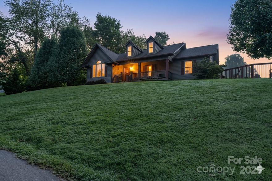 Sellers are offering up to $10,000 in concessions with an acceptable offer — perfect for a rate buydown, closing costs, or updates. A lender-funded 1/0 rate buydown option may also be available to help lower your interest rate for the first year for qualified buyers. Ask your agent for details.

Your mountain lifestyle starts here — pool, land, main-level living, and freedom from HOA rules. Just 3 miles to Burnsville and minutes from 19E, this home combines comfort, quality, and convenience in one inviting package. Soaring cathedral ceilings with Eastern white pine tongue-and-groove set the tone in the open living, dining, and kitchen area — a bright, welcoming space designed for everyday living and entertaining.

Timeless hardwood floors, maple cabinetry, a pantry, and fresh interior paint throughout the main living areas make the heart of the home feel both polished and comfortable. All three bedrooms, two full baths, and the laundry room are conveniently located on the main level — no stairs, no hassle. Built-in stairs lead to a large walk-up attic, offering excellent storage or potential expansion space.

Downstairs, the finished lower level adds exceptional versatility — perfect for a home theater, guest suite, gym, or private workspace. This area includes a full bath, drive-in garage bay, and dedicated storage/workshop space, and can also be accessed directly from the driveway through the patio door, allowing for a semi-private entry if desired.

Step outside to your own retreat: an in-ground fenced pool, a level yard for play, and a large outbuilding plus carport for hobbies or extra parking. Bring the RV, bring the chickens, or bring your short-term rental vision — with no restrictions, you call the shots.

Recent updates include a new HVAC (2024), newer exterior stain, and fresh paint in the main living areas — move-in ready from day one. The location offers the best of Western North Carolina: a peaceful setting with quick access to Asheville, Weaverville, Johnson City, and Burnsville’s vibrant downtown.

Enjoy quiet mornings on the porch, days by the pool, and nights under a sky full of stars. Here, the pace slows, the stress fades, and the mountains do their magic.

Opportunities like this are hard to find — main-level living, a private pool, and usable acreage all in one move-in-ready package. Stillwater Springs isn’t just a home; it’s the lifestyle you’ve been waiting for.