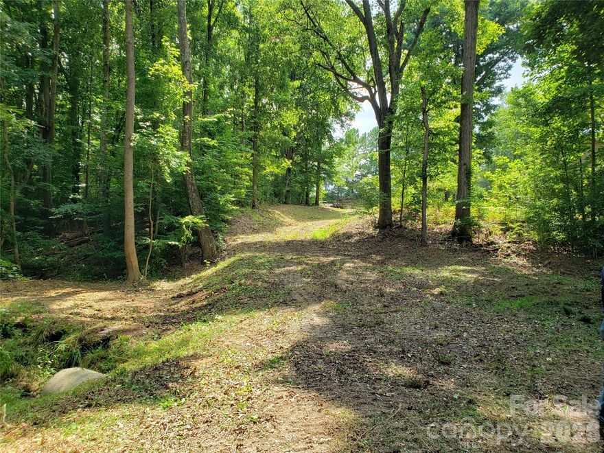Hard-to-find ±14 acre rural retreat near Rock Hill offering the perfect blend of privacy and convenience. Located on West Oak Drive between Mount Gallant Road and Celanese Road, this property provides quick access to I-77, is less than a mile from Lake Wylie, and just minutes to Rock Hill or York, shopping, dining, and everyday amenities.

Ideal for a family compound, this tract offers the space and flexibility to create a multi-home setting while still enjoying a peaceful, tucked-away environment. Per York County, the property may be subdivided into up to three parcels with a shared driveway—perfect for extended family or a legacy property. The land features a year-round stream, mature hardwoods with some pines, and a gently rolling to mostly level layout with multiple prime homesites. The property is is in York County and is zoned RUD.

A partially constructed driveway provides a head start for access—simply extend to your preferred building site. Properties of this size and setting—so close to Lake Wylie and central Rock Hill—are increasingly rare.

Address not yet assigned and is approximate for GPS location use only. Well and septic required at buyer’s expense. The mobile home beside the driveway is a separate property and is not included.