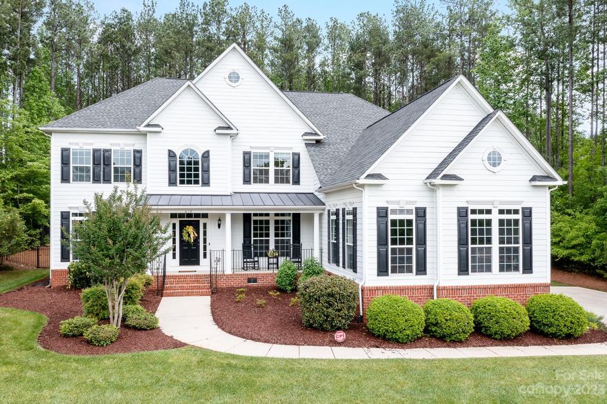 Pride of ownership shows in this stunning home loaded with extras in Clover schools in back of neighborhood for privacy & little traffic. One-owner on almost 1.2 ac has an expansive chef's dream kitchen w/double ovens, gas cooktop & huge island. Main floor boasts Grand Entryway, LR, DR, FR, Ofc, oversize Breakfast, built-in bar, lots of closets, dual staircases & Laundry w/built-in cabinetry, sink & counters. HUGE 2nd-floor Primary BR suite w/ spacious sitting area + 2 BIG custom-designed closets & an owners bath to please. All BRs spacious. Enviable 3rd-floor bonus/flex room & climate-controlled walk-in storage/exercise rm. Home sits on a gently sloping hill & offers over 5000 SF w/ a private peaceful fenced backyard w/irrigation & designer patio & built-in grill.  Desirable low maintenance fiber cement siding, rocking chair front porch & some Lake Wylie views or walk the block for lake views galore. Neighborhood has RV/Boat storage & 2 pools. Field Day Park,marinas are minutes away.