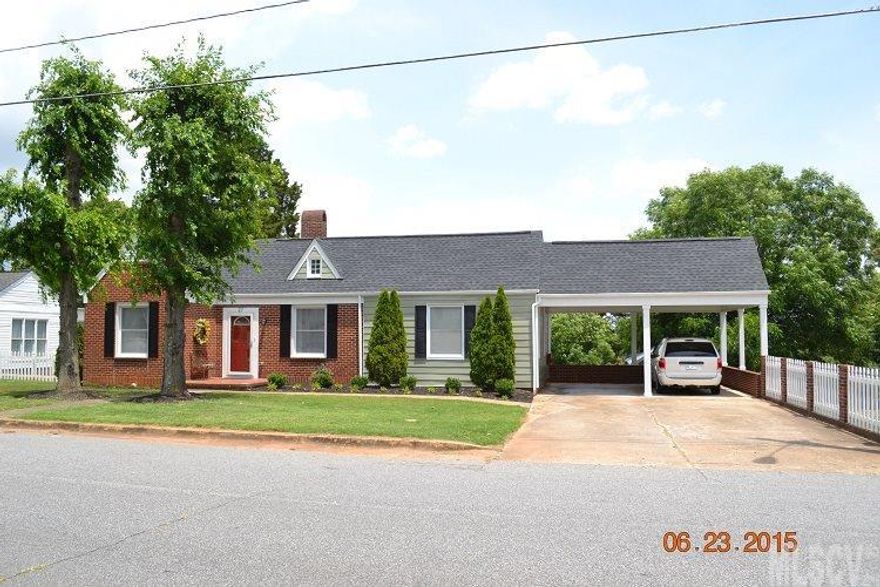 Move in ready! Absolutely adorable 3BR, 2 BA ranch, Beautiful hdwd flrs, no carpet in this home!  2 fireplaces, replacement windows, freshly painted interior and exterior, updated kitchen with cabinets added, new bath fixtures, covered rear porch as well as an amazing patio for outdoor entertaining, double carport attached, 10 x 20 wired building and more! Just needs a new owner!