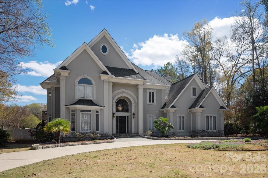 Waterfront living meets timeless design in this custom-built home in Meadow Lakes II. Offering nearly 4,800 square feet, this 4-bedroom, 3 full and 2 half bath residence blends expansive living spaces with thoughtful craftsmanship and stunning lake views throughout.

The main level showcases rich Brazilian cherry floors, custom built-ins, and multiple gathering areas designed for both everyday living and entertaining. The kitchen is well-appointed with high-end appliances and opens to a warm and inviting keeping room, creating a natural hub for connection and relaxed living. A whole-home 7-zone speaker system (4 inside/3 outside) enhances both indoor and outdoor living.

Upstairs, the spacious primary suite offers a true retreat, where you can wake up to peaceful water views each morning. The suite is complemented by a spa-inspired bath and a custom walk-in closet, creating a comfortable and well-appointed private space. Generously sized secondary bedrooms and a large bonus room featuring built-ins, a cedar closet, desk area, and multiple walk-in closets provide exceptional and functional storage. A dedicated study with custom cabinetry offers a refined and flexible space for working from home.

Step outside to a true backyard experience. A bluestone terrace with a striking outdoor stone fireplace and built-in Bull grill sets the stage for year-round enjoyment, overlooking an expansive paved patio with a lighted saltwater pool, cascading water features, and spa. Thoughtful details like LED lighting integrated into the stone columns and steps elevate the ambiance, while mature landscaping and palm trees frame the setting. Whether hosting or unwinding, the outdoor spaces are designed to shine day or night with peaceful lake views as the backdrop.

Located in the established Meadow Lakes II community with access to clubhouse, pool, and tennis amenities, this home offers a rare combination of space, setting, and lifestyle.