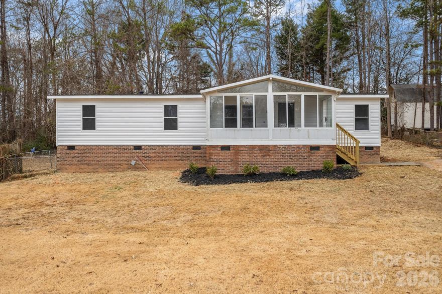 Beautifully remodeled home waiting for you! Walk up the front stairs into the STUNNING sunroom, SO much natural light to take in and enjoy! NEW LVP Flooring throughout the entire home! Entertain guests around the wood burning fireplace in the Great Room, the spacious dining room, or the dining area in the kitchen! The kitchen is AWESOME featuring white shaker cabinets, NEW countertops, and NEW SS Microwave, range, and dishwasher.  NEW SS Appliances are on order and will be delivered and installed ASAP.  The Laundry Room is located right off the kitchen for your convenience. Primary suite is a GREAT size hosting a Vaulted Ceiling, Ceiling Fan. nice walk-in closet and full bathroom w/dual vanity, walk-in shower, and BIG Garden tub! So much space! Both guest bedrooms are good sizes and share the additional full bathroom w/single vanity and tub/shower combo. Outside you will find a NEW deck in the backyard to enjoy those NC summer nights!  NEW Gutters will be installed on 1-26-26.  Come see this one today!