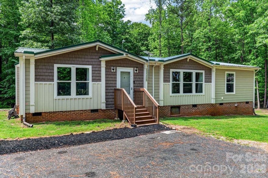 Craving space, privacy, and freedom from HOA restrictions? Welcome to your private retreat on 14 serene acres surrounded by mature hardwoods. Built in 2017, this charming 3-bedroom, 2-bath home offers a thoughtfully designed split floor plan with inviting, comfortable living spaces throughout. A recently added 30x35 detached garage/shop is wired and ready for your hobby or small business needs. Within the last two years, this home has received all new HVAC, flooring, kitchen appliances, paved driveway, and structural improvements. The heart of the home is a spacious eat-in kitchen featuring a center island, pantry with a stylish sliding barn door, and plenty of room to gather. An oversized laundry and craft room adds extra flexibility for hobbies, storage, or workspace needs. The owner’s suite is a true escape—bright and airy with soft neutral tones, a spa-inspired bathroom complete with an oversized tiled shower, and a separate soaking tub perfect for unwinding. Step outside and take in the peaceful surroundings from the large deck with included patio set—ideal for relaxing or entertaining while overlooking your own private sanctuary. A durable raised-seam metal roof was installed in 2022 for added peace of mind.