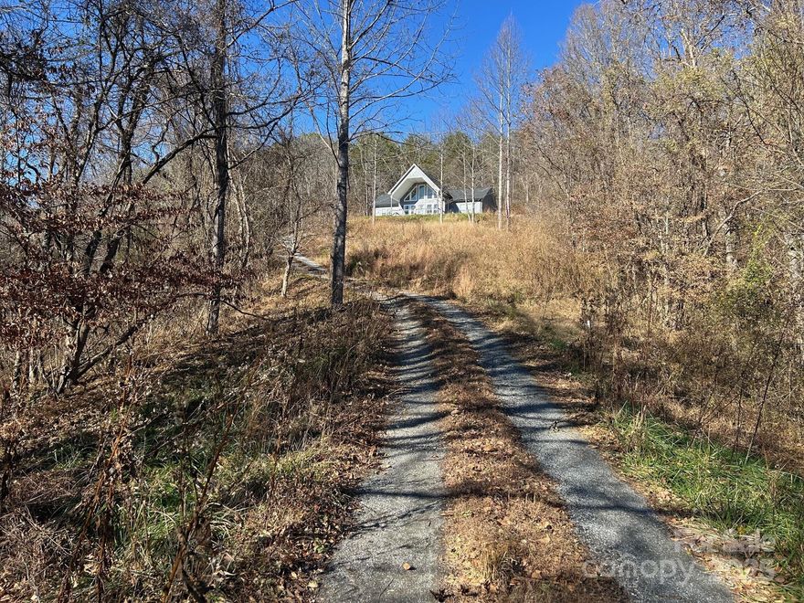 Welcome to Starry Night. Beautiful mountain views with newer home built in 2021 on 6.35 acres. Open living, kitchen & dining areas let you take in the airy views. Perched on an open knoll with long range views to the south & west. This small community of Redmon Ridge and light restrictions in place. Home has a large covered porch for stargazing or utilize the back porch for grilling & more entertaining. All one level living, sets this home up for ease of access. The home has been pre-wired for a generator. HVAC is electric with propane back up for efficiency. The living/dining/kitchen area separates the primary bedroom from the 2 bedrooms & a full bath. The primary bedroom has an en suite bath and closet, with large soaking tub. 

Located right above put-in at Redmon Damm for the river enthusiasts. Which allows public access to rafting, canoeing, fishing, etc. Convenient 5 minutes to the Town of Marshall NC or.. 30+/- mins to City of Asheville.
