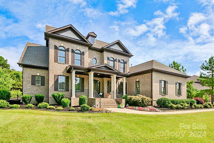 Meticulously maintained, striking home in gated community. Welcoming two-story foyer leads into open floor plan w/10' ceilings and 8' doors. Plantation Shutters (3") on all 36 windows in home!  Great room w/stone fireplace, built-ins, coffered ceiling, beautiful, large, eat-in, gourmet kitchen w/granite countertops, formal dining room & butler's pantry, primary bedroom ensuite along with guest bedroom/full bath and powder room makeup the main floor. Custom made wool runner in foyer & carpeted staircase. Upstairs offers 3 additional bedrooms, 2 baths, media room and large, walk-in storage.  A covered & screened-in veranda off kitchen opens to a private, outdoor oasis!  Large pavilion w/outdoor TV, kitchen, beautiful stone fireplace & gathering area sit adjacent to a stamped concrete patio with inground pool overlooking unencumbered views of large fenced-in backyard.  A Rainbird, 6-stage water sprinkler system provides ease in keeping this professionally, landscaped yard a breeze.