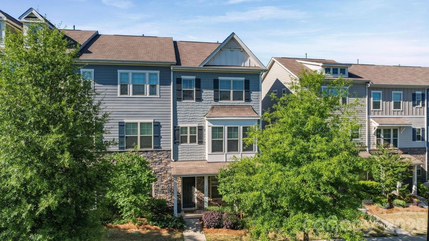 Welcome to this meticulously well maintained 3-story END-UNIT townhome with views of an open green field! Stepping into the ground floor you will see a good-sized entry hall with a "drop zone”, a versatile guest suite or office with a full bath and access to a 2-CAR GARAGE. Upstairs you will be greeted by a bright and open layout that offers the chef’s kitchen equipped with stainless steel appliances, gas range, grey cabinets and oversized granite countertop. Soaring 10-foot ceilings certainly enhance the open-concept floor plan, flowing seamlessly from the gourmet kitchen to the spacious living and dining areas. On the 3rd floor the private primary suite is a luxurious retreat featuring ensuite bath with double vanity and stunning shower room, a tray ceiling, and a large walk-in closet. Two additional bedrooms and a full bath provide more space for family and guests. Community amenities include a pool, cabana and grilling area. Plus, just a short walk to Arrowood Station for Charlotte Light Rail, a quick access to Uptown, South End, and more!