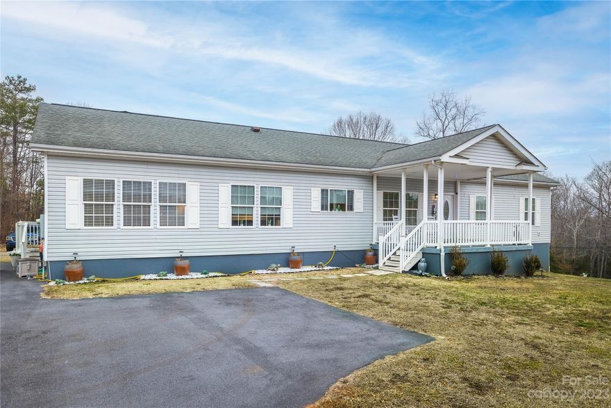 Fantastic value....this spacious 1 level home offers 4 beds, 2 full baths, open concept living, dining, kitchen, laundry, and family room all on one level! Even better there is a full unfinished basement with high ceilings and 0.85 acre lot outside of city limits! Updates to the home within the past two years...SS appliances (double ovens), granite counters, interior paint, water heater, paved parking area w/ turn around, flooring, front door, bathroom vanities, building, partial fence in backyard, and more! The spacious primary bedroom offers a walk-in closet and large full private bath with custom tiled shower. Two of the remaining 3 bedrooms have walk-in closets. Tile and LVP hardwoods throughout the entire home. Outside enjoy the level backyard and covered front & back porch. Great location close to HWY 70 and I-40.