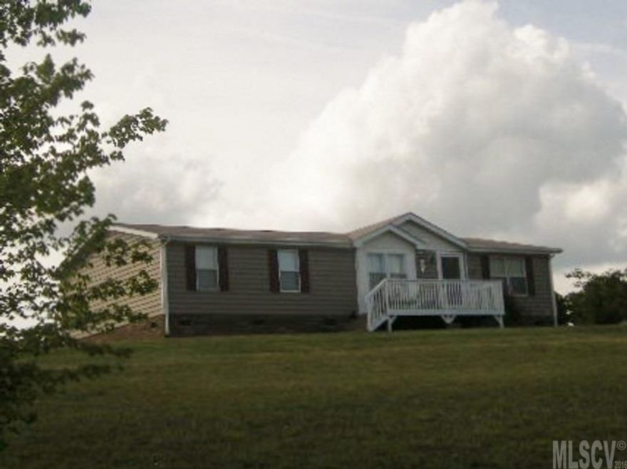 Absolutely Adorable, well kept home with split bedroom floor plan. Fresh paint on inviting front porch. Spacious living room with vaulted ceiling, dining room, pretty kitchen with lots of cabinets, work island, & walk-in pantry. Master bedroom flows from LR with updated bath. Two bedrooms, Den/Office room and Hall Bath on other end. Separate laundry room with cabinets. 12x12 work building, large backyard, mature Leland cypress lined driveway. Perfect home for country living but close to town.