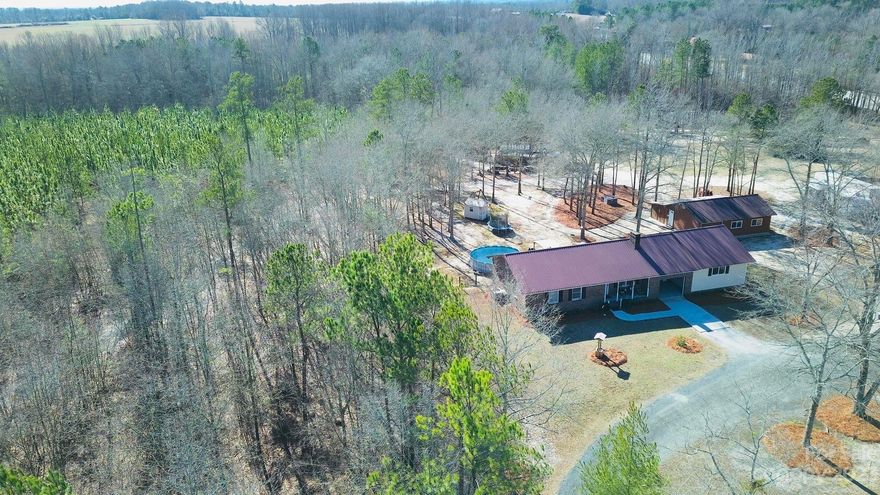 Life in the country! Check out 96 Sandhills VFD Rd, Jefferson, SC.  Located just five minutes outside the precious town of Jefferson, this home is a dream come true.  Three bedrooms, three full bathrooms with a LARGE shop that has central heating and cooling, and could be used for additional living space and a one car garage with storage space. Large master bedroom with his and her walk in closets, master bathroom with a garden tub and walk in shower and two additional full bedrooms and bathrooms. With a large front and back yard, you will have all the privacy you need.  Stocked fishing pond, 7.5 acres, above ground pool, back patio, ...  this home has it all and is ready for YOU!  Come enjoy the peaceful, country life!  Don't let this one pass you by!