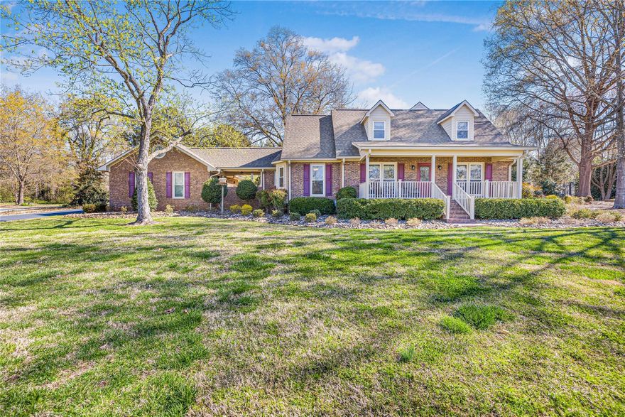 Do you want space and still be close to everything. This large home sits on 2.5 acres in the Mountain Island Lake area walking distance from Library & Restaurant and under a canopy of large trees. You will have the feel of the Country. All new kitchen with gas range & upper cabinets with feature lighting welcome you home. Your sunny breakfast room adjoins your new kitchen and features a large bay window and both have gleaming wide plank hickory hardwood flooring. Your primary BR&BA are also located on the main level. There is a large family room with fireplace that is a great spot for gatherings of a small social event or you can host a large gathering in the vaulted 2 story great room with the expansive windows that leads to the 3-season room. Upstairs has a small den/office & 2 add BR's. This huge property boast a dream workshop with heat/air and is spotless! There is also additional storage upstairs. Don't miss the detached garage with abundant space & another barn on far corner.