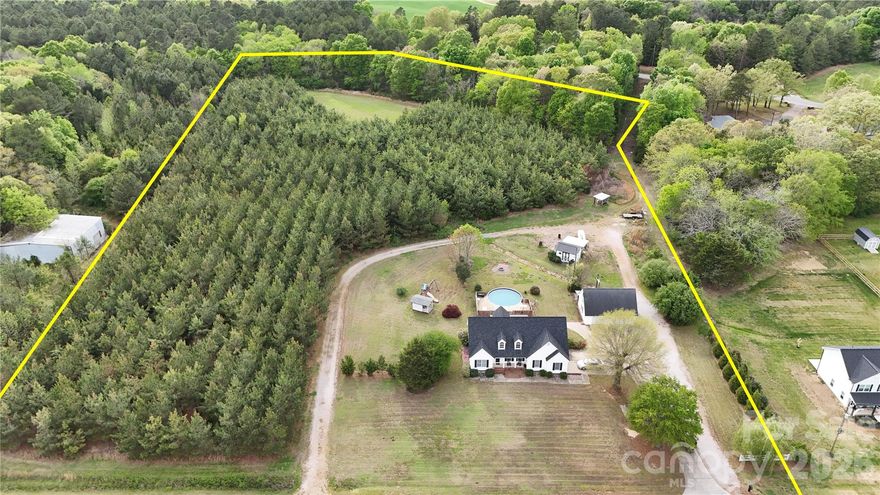 COMMUTER’S DREAM WITH ACREAGE & PRIVACY – RECENT PRICE IMPROVEMENT!
Located in South Carolina right at the North Carolina state line and the Lancaster County line, this property offers the perfect balance of peaceful country living with quick access to Monroe, Lancaster, Charlotte, and Pageland—ideal for commuters who want space without sacrificing convenience.

Positioned along a desirable stretch of road with beautiful newer homes nearby, this is the last home past the new construction, offering added seclusion. The seller also owns the land to the left of the home (when facing it), creating a natural privacy buffer, while the property across the street is open farmland—giving you the quiet rural setting buyers are searching for.

The home features 3 bedrooms, 2.5 bathrooms, plus a spacious FROG with a massive walk-in closet, perfect for a home office, guest suite, or flex space. Major updates include a new roof (2020) and an HVAC system only 5 years old, and all appliances—including washer and dryer—convey.

In addition to the attached two-car garage, the property includes a 24x32 detached garage/workshop that is already framed for an in-law suite with flooring installed, ready for your finishing touches—ideal for multigenerational living or future income potential. You’ll also find a 12x16 storage building, an above-ground pool with a new deck, pump, and ionizer, and a covered back patio perfect for entertaining.

The land offers approximately 4 cleared acres with the remaining acreage in pines and hardwoods, along with a shooting range and a cleared space for hunting or outdoor recreation—making this a rare find for buyers seeking acreage, privacy, and flexibility.  Move-in ready with major systems updated; cosmetic finishes offer an opportunity to customize and create value.  Seller is offering a $5,000 allowance with an acceptable offer for any cosmetic updates you desire.

Recently reduced and competitively priced for the location, land, and features—this is a standout opportunity for commuters and acreage buyers alike.