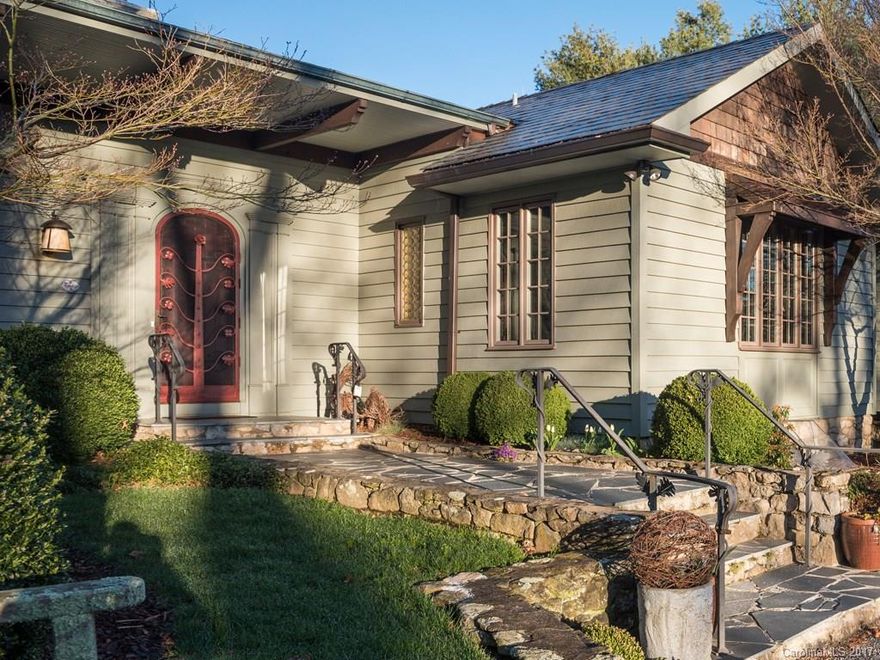 Gracious Old World charm on top of Sunset Mountain overlooking Asheville and the mountains.This home blends charm with modern updates .Great home for entertaining with flowing floor-plan which opens to the outdoor living space. 3 level lush acres with  gardens to enjoy . Arched doorways,vaulted & 9ft ceilings, walls of windows, 2 fireplaces, spacious dining room, living room plus library , Hardwood floors, tennis court ,slate roof , copper gutters are just of few of the qualities in this home.