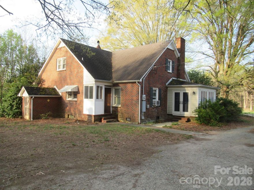 Diamond in the Rough in Sherrills Ford!  Bring your vision and transform this classic 1950s brick home into something truly special. Located in the heart of Sherrills Ford, this property offers incredible potential and is just minutes from Lake Norman public access, as well as Hwy 150 with convenient access to Mooresville shopping, dining, and entertainment.  The home features 2 bedrooms and 1 full bath on the main level, with an additional bedroom and loft space upstairs—offering flexibility for expansion or creative redesign. With the right updates, this property could be restored into a true showplace.  A standout feature is the detached garage/workshop, which includes a fully finished upper-level bonus space—ideal for a recreation room, studio, or private retreat.  Situated on 3.88 acres, the property offers approximately 333 feet of road frontage on Sherrills Ford Road and extends over 400 feet deep, providing space, privacy, and endless possibilities. Whether you’re considering a renovation project, investment opportunity, or future homesite, this property is positioned in a rapidly growing area of Catawba County.  Endless possibilities—don’t miss your chance to bring this property back to life!