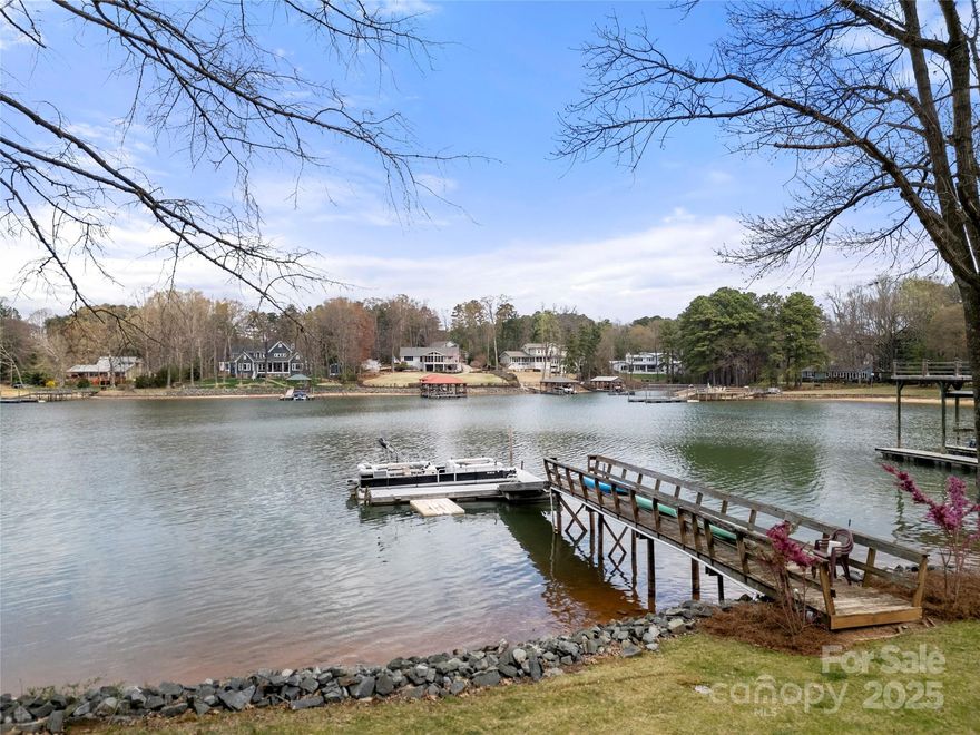This lakefront property offers over three-quarters of an acre of waterfront living w/no HOA & includes the added luxury of a private pier & floating dock. The lot presents versatile opportunities—ideal as a rental investment or the perfect location to build your dream lake home. Inside, the kitchen is equipped with stainless steel appliances, including a gas range & dishwasher, along w/granite countertops & a center island. The living room includes wood accents & exposed ceiling beams, seamlessly flowing into the adjoining dining area. A bedroom & full bath complete the main level. Upstairs the primary suite features walk-in closets, ensuite bath & access to an elevated balcony w/lake views. Step outside to enjoy a wraparound deck that leads to a back porch complete w/ hot tub. Additional structures on the property offer even more possibilities; however, all are being sold as-is. Don’t miss your chance to experience everything this unique lakefront property has to offer.