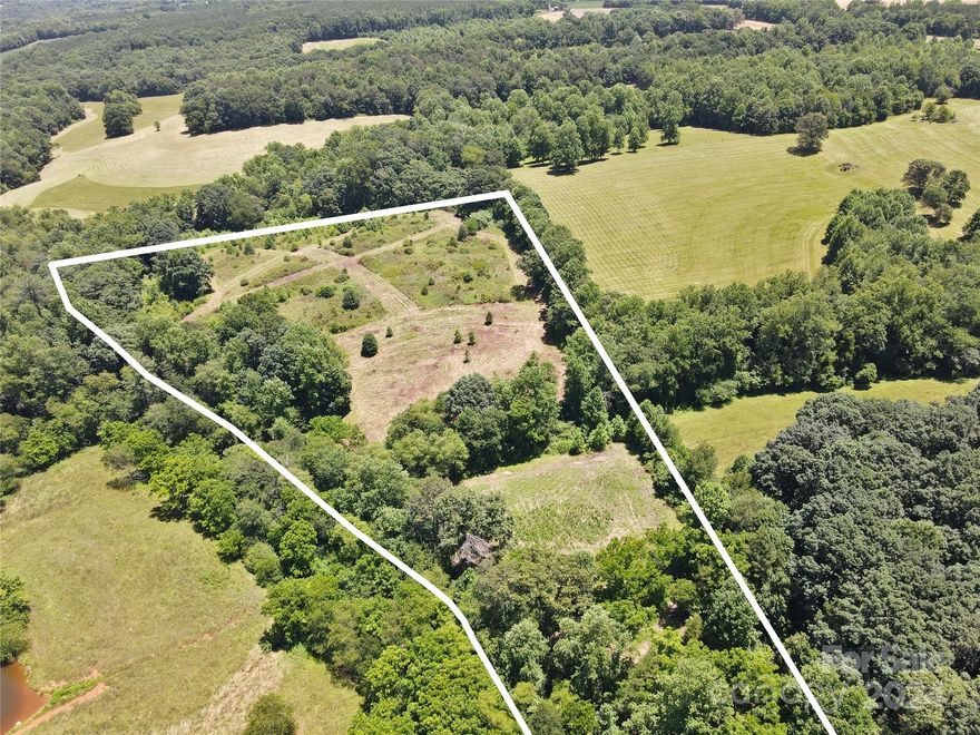 Here are 9 + acres in the heart of Union Grove!  Private location with a deeded/platted right of way leading to the property.  The beginning of the property has a small stream crossing it and and then another small stream starting from a spring flowing through it as well.  There's nice wooded areas and two fields with one field being a little over an acre and the other field approximately 4 acres.  Enjoy seeing the deer cross your property and other wildlife call it home too! It's really a convenient location tucked away off Howards Bridge Rd. with I-77 access only approx. 4 min drive. Statesville about 20 min, Wilkesboro about 25 min, Boone & other Mtn towns approx 1 hour.  Right on the edge of Yadkin Valley and wine country as well. Great place to build and/or have your mini farm etc.  Come enjoy what this rural community has to offer throughout the year!
