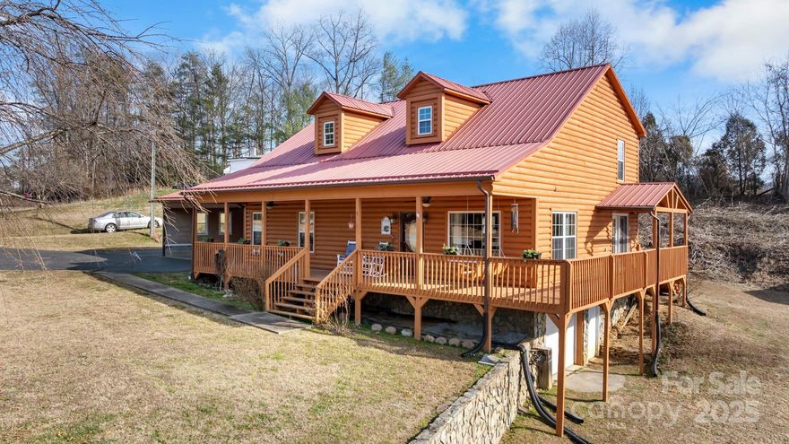 Country, rustic living on 1.39 Acres. You will fall in love with the large wrap around porch on this well maintained log home. As you enter, you will be greeted with towering ceilings and a loft area overlooking the living room. The open floor plan is great for family gatherings or entertaining. The kitchen has a bar area, double ovens, SS appliances and a walk-in pantry.  Main level primary suite and main level laundry. ALL appliances remain including the refrigerator and washer/dryer.  Upstairs the loft area provides a great sitting area or second living space.  The full unfinished basement offers a single car garage, wood stove and lots of storage area.  Large detached workshop and additional storage building.  Very spacious fenced lot for dogs.
