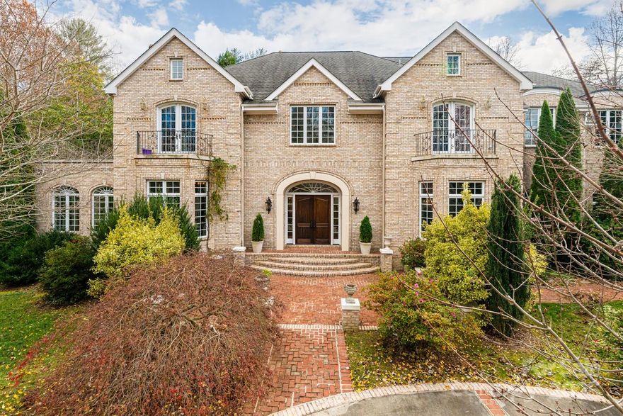 LUXURY RESORT-STYLE LIVING ON A PRIVATE 10+ ACRE ESTATE. Experience the pinnacle of elegance and seclusion on this breathtaking 10+ acre resort-style estate, offering unmatched privacy and an unforgettable arrival. A long, private driveway guides you to one of the most magical properties in Western North Carolina—an extraordinary residence boasting over 7,200 heated square feet, plus an additional 1,300 sq. ft. of attic space, 2,000+ sq. ft. of unfinished basement, and a three-car garage for a total of 11,000+ sq. ft. under roof. Designed for grand living and effortless entertaining, this estate showcases expansive rooms and exquisite architectural details throughout. The main level features a stunning conservatory, a richly appointed study/library with cherry built-ins, fireplace, and coffered ceilings, an elegant formal living room, and a spacious great room with fireplace, custom built-ins, and a convenient wet bar. The professional chef’s kitchen is fully outfitted with high-end appliances—two wall ovens, microwave, gas cooktop, and an oversized island with breakfast bar. Enjoy casual meals in the sunlit breakfast room overlooking the terrace, or host unforgettable gatherings in the formal dining room. A butler’s pantry, powder room, and large laundry room complete the main level. An elegant staircase leads to the luxurious primary suite, a true spa-like retreat with fireplace, private deck, two walk-in closets, heated tile floors, jetted tub, dual vanities, and a walk-in shower. The upper level also offers multiple guest bedrooms and baths, along with a spacious guest suite featuring a kitchenette and bonus room. Step outside and experience outdoor living at its finest. Relax on the balconies, terraces, or patios; stroll the brick paver walkways to the magnificent pool and fountain area; or unwind by the serene koi pond with waterfall. Multiple gardens, meandering pathways, and lush landscapes create your own private resort sanctuary. A rare, one-of-a-kind estate—conveniently located near Asheville, Hendersonville, Brevard, and all the beauty and adventure Western North Carolina has to offer. Truly extraordinary. Truly unforgettable. Welcome home.