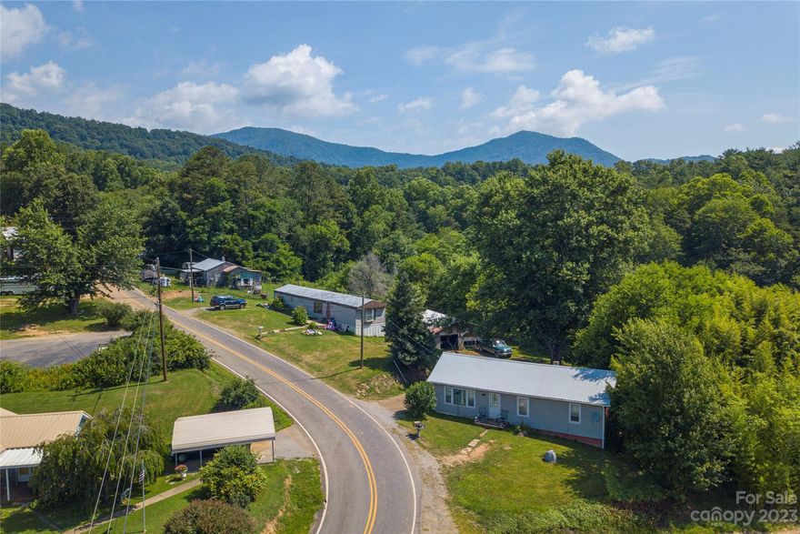 This 2.45-acre property just N of Canton is a great opportunity for someone looking to invest or live w/family. It has 3 homes: a site-built house, a single-wide mobile home, & small cottage. You can live in one & rent the other two, or rent all three to make extra income. The land is unrestricted, so you have the freedom to use it in many ways. It was once home to horses and still has plenty of space for animals, gardens, or outdoor fun. There’s also a large 2-bay garage that can be used as a workshop or for storage. You’ll enjoy the peaceful setting w/open land, pretty mountain views, & quiet creek that runs along one side of the property. Even though it feels private, it’s just a short drive to downtown Canton, Waynesville, & Asheville. Tenants are living in the site-built house, so showings are by appointment only. Please do not visit without permission. This property may qualify for up to 10 down payment help programs. Call today to learn more.