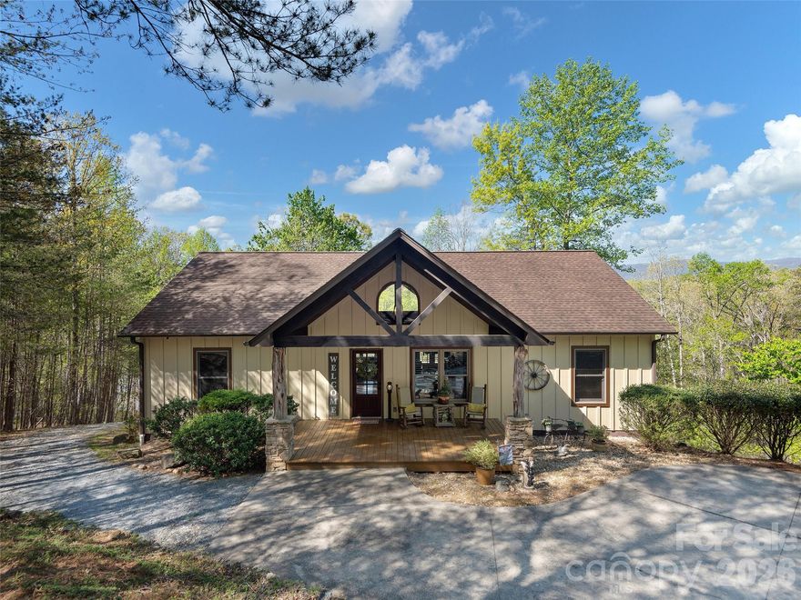 Experience lake and mountain living in this stunning Lake Adger lakefront home! Enjoy views of both the water and mountains from your own backyard. This is a true mountain lake house. The inviting covered front porch welcomes you with unique tree columns and a soaring vaulted wood ceiling, creating a warm, rustic ambiance. Step inside to an impressive great room featuring stunning post-and-beam details, apex windows, and a vaulted wood ceiling. The open-concept layout seamlessly connects the kitchen and dining area ideal for entertaining. Extend your living space outdoors onto the expansive back deck, where water views of Lake Adger and the mountains create a picturesque backdrop for gatherings. The main level also features a spacious primary ensuite, two guest rooms, and a guest bath all adorned with rich wood accents that add charm and character throughout the home. Downstairs, the spacious recreation and family room is ideal for entertaining, whether you're enjoying a game of billiards or relaxing with friends. The beautiful wet bar with a natural wood edge top makes hosting easy, and the bonus room, full bath, and ample storage offer plenty of flex space. Step out onto the lower patio to extend your living outdoors. Outdoor amenities include a cozy firepit with a sitting area, a gravel path leading directly from the house to the lake, and a private floating "deep water" dock for your boat and other lake activities. Please be sure to check out the video virtual tour. This exceptional home is ready to deliver the mountain lake lifestyle you've been dreaming of!