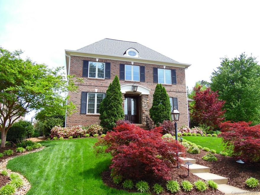 Stunning home in exclusive gated community with views of Lake Wylie!  Open and inviting floor plan features master on main, vaulted living with 2-story stone fireplace, fabulous custom kitchen with granite, formal dining, and office.  Upstairs offers two spacious bedrooms with their own individual bathrooms, plus huge walk-in attic space.  Don't miss the "secret garden" through the natural archway on the side of the house!  Community pool, club house, and beach area.