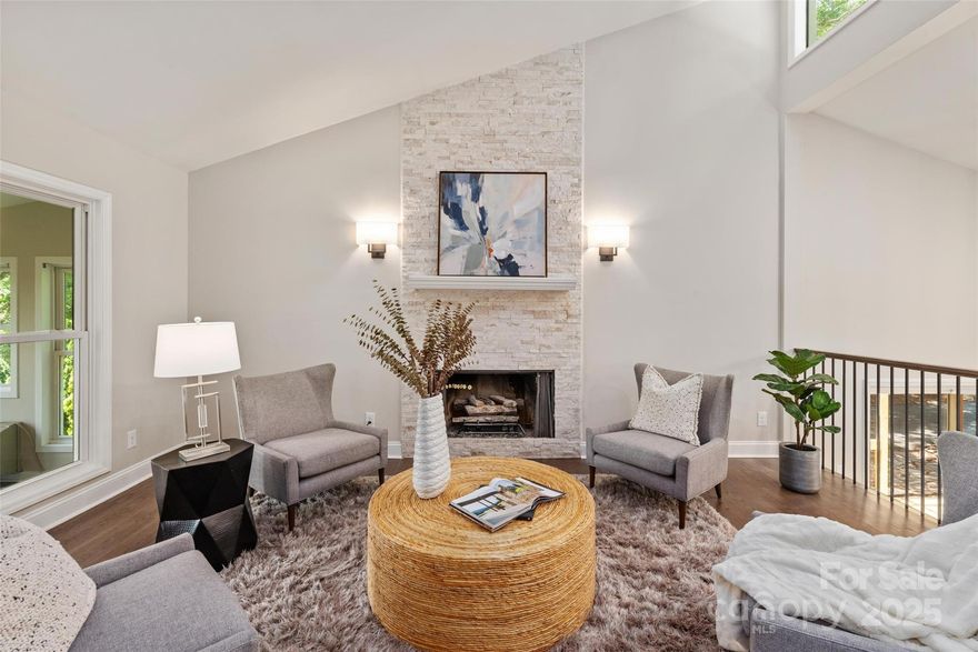 This stunning Tega Cay renovation offers year-round water views and an incredible makeover! Upon entering, you'll find a spacious sunken living room/family room/office/bonus room, perfect for versatile use. Step up into the fabulous renovated kitchen and dining area, which was completely transformed by removing the wall between them to create an open, inviting space for family and friends. The area features new canned lighting, cabinetry, stainless appliances, and a huge island. 

Just a few steps up lead to the upper level, where the primary bedroom boasts a redesigned en-suite bath with a large walk-in shower, new vanity, lighting, and tile flooring. The upper level also includes a cozy family room/den with a stunning stone fireplace, new flooring, and modern railing. French doors open into an enclosed sunroom with new tile flooring and a mini-split system for year-round comfort. 

On the lower level, you'll find four bedrooms, a gorgeous laundry room with new cabinets, a sink, new flooring, and a new full bath. There's also another sunroom, complete with a mini-split system and access to a screened porch and brand-new deck. Additional public parking is available to the right of the home. 

Please refer to the list of improvements in MLS.  All renovations were properly permitted and approved by Tega Cay. This home is truly a remarkable transformation you don't want to miss!