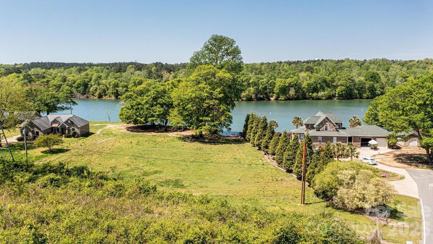 Waterfront Lot available on Lake Wylie!  Mostly cleared, level lot ready to build your lakefront home. New flood zone requires any new construction to be raised. Conveniently located near Hwy 16 & 485 for easy access to Uptown, Airport, shopping, dining, Top Golf and more! Adjacent lot (1408 Hart Rd) also available for sale.