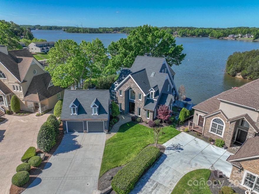 Rare main channel home with sweeping views AND marked no-wake zone.  Bright, airy home is perfect for enjoying the peaceful setting.  Deep water dock - bring your boats, PWCs, kayaks, and SUPs to enjoy the lake life!  Charlotte address with easy access to Ballantyne (25 min), Southend (25 min), Rivergate shopping (5 min), and new River District (10 min).  Spectacular custom home spanning 4,375 square feet with four bedrooms, three full bathrooms, two powder rooms, and outdoor shower for rinsing off after lake activities.  Unit above garage is heated and cooled and can be utilized as a gym or storage.  Enjoy the outdoors with plenty of decks for sunning, reading, having lunch with friends, or hanging out by the fireplace in the evening!