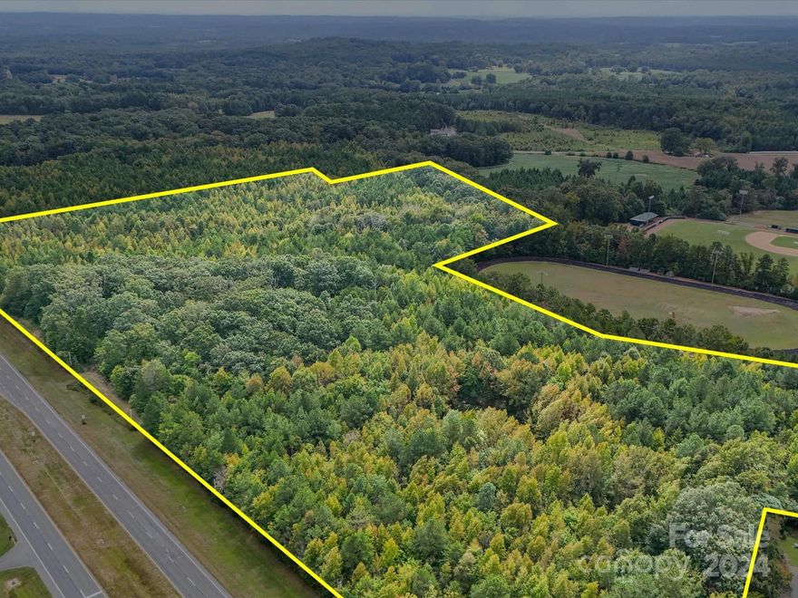 Prime Real Estate - Currently Zoned H-B - situated along Hwy 24/27 in Red Cross Community - - Oakboro address.  Land is to the east side and borders West Stanly High School.  Over 2400 feet of highway road frontage along 24/27 and rear access of over 400 feet along Lakewood Road.  3 Parcels totaling 51.08 acres.  County water runs along 24/27 - - access and tap fees required.  Drainage easement/open ditch exists - see survey.

See Land Listing - MLS # 4183118