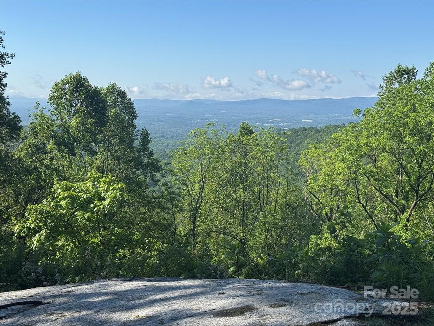 Lot 70 in Sprout offers one of the best double views around. Enjoy breathtaking south-facing views from your future back deck, and stunning north-facing views from your front porch. A gentle driveway is already in place, and the massive boulders framing the lot create an impressive entrance.
Sprout is Asheville and Hendersonville's newest conservation community offering the residents a place to live a healthy in a nature focused way while still enjoying the comforts of connecting with your neighbors as well as being conveniently located. The community gives owners a way to connect with nature through the community gardens and miles of hiking and mountain biking trails that wind throughout the 150 acre conservation preserve. The conservation area cannot ever be developed in the future and is only for the enjoyment of Sprout owners.
