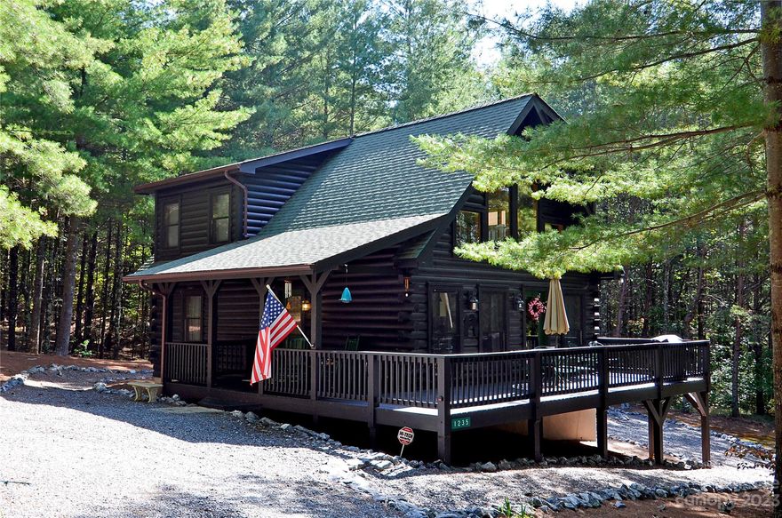 Nestled in the trees, this 2 bedroom, 2 bath log cabin offers a warm and inviting ambiance that will make you feel right at home. As you step inside you'll immediately notice the natural beauty showcased throughout. The open-concept floor plan seamlessly connects the living, dining, and kitchen areas, making it perfect for entertaining family and friends. The tranquil primary bedroom is a true retreat, with an ensuite bath and plenty of closet space. Wake up to breathtaking views of nature and start your day peacefully. The second bedroom also offers ample space and can be used as a guest room or a home office. Step outside onto the deck and take in the beauty of your surroundings. Enjoy your morning coffee, host a bbq, or relax and unwind while listening to the sounds of nature. Enjoy the tranquility while still being close to local amenities and attractions. Whether you're seeking a weekend getaway, VRBO, or a permanent residence, this log cabin is the perfect place to call home.