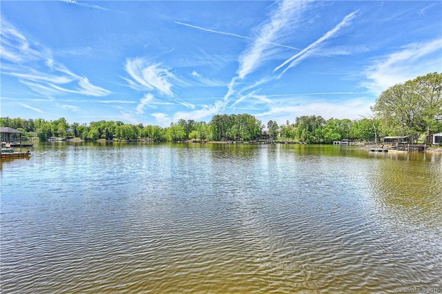 Hard to find large level lot in Lake Wylie! Live in the home & fix it the way you like or tear down. The lot is already permitted for demo and could build a 5000 square foot home if you like. This west facing waterfront lot has some great sunset views and located in a deep water cove. Boat house and dock! Easy access to restaurants, shopping and short commute to Charlotte! Home being sold as is.