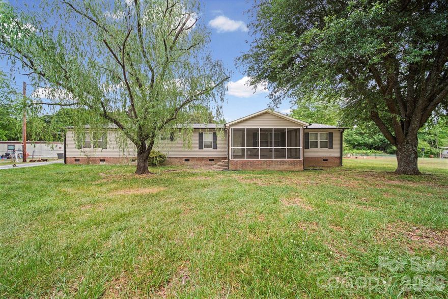 Spacious property that offers over 2,000 sq. ft. of living space, situated on nearly one acre of land.

The home features a large primary bedroom with a split floor plan, providing privacy from the three additional bedrooms. Outdoor amenities include a screened-in front porch, a back deck, and two outbuildings for extra storage. This property offers a wonderful opportunity to customize a home to your preferences.

Please let me know if you would like more information or if you are interested in scheduling a viewing.