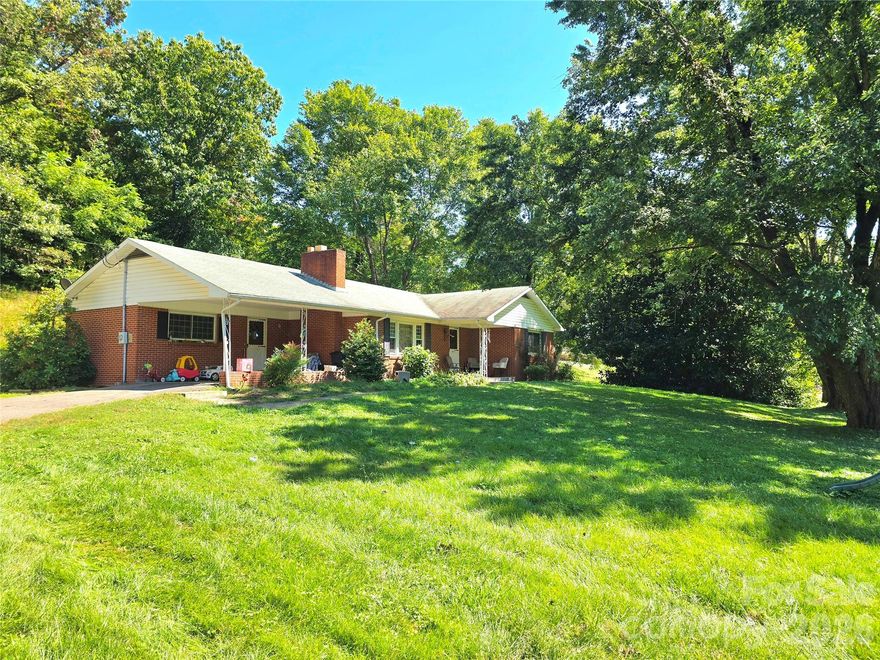 Certified Pre-Owned - CPO home + video available shortly! Charming brick ranch on almost one flat acre with a bright, open-feel kitchen/living layout and recent updates including new flooring plus fresh paint/refresh. Full basement exterior entry offers great storage/workshop potential/living area. Attached carport + asphalt drive. Convenient location, about 12 min drive to Weaverville, 20 min to downtown Asheville, and a short drive to Mars Hill University. Less than 5 minutes to Publix and Ingles, and other shopping and conveniences. Owners are just finishing up last touches so more pictures and videos soon. Lower level is currently being finished and will be completed before sale.