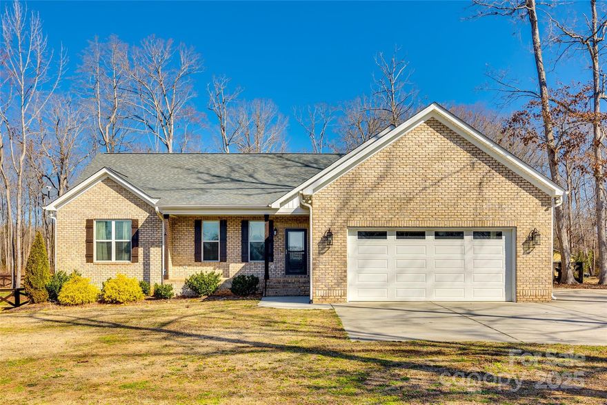 Custom Full brick Ranch home on a sprawling 2.34 acre lot with lovely landscaping! This Home offers great finishes throughout including hardwoods throughout the main living area, a beautiful kitchen with granite counters, subway backsplash, undermount lighting, and stainless steel appliances, walk-in pantry, custom fireplace, tankless water heater, screened in porch, and professional landscaping. The family room has a lovely stone fireplace and offers an open concept living area. All bedrooms are on one side of the home for convenience and have brand new carpets just installed. The primary bedroom has a large spa like en suite with dual vanities, walk-in shower and a separate water closet. Step outside to the relaxing screened in porch overlooking the patio and professional landscaping around the fenced in back yard with mature natural hardwoods. The lot is very spacious with over 2 acres!