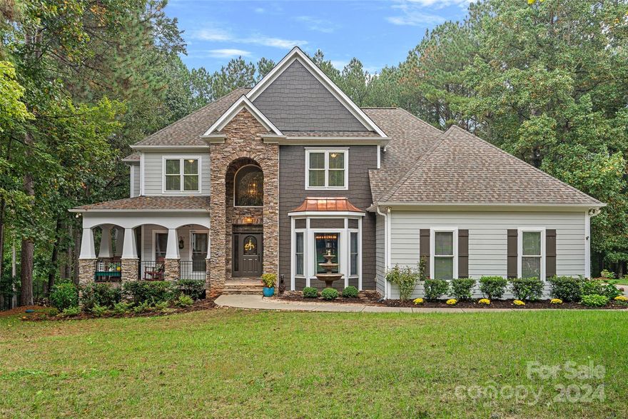 Custom home in waterfront community on Lake Norman includes a deeded boat slip! Enjoy lake living year round with community amenities galore! This Craftsman style home with an expansive deck overlooks a gorgeous private wooded backyard. Wraparound front porch with two-story entrance greets family and friends. Main level great room with stone gas-log fireplace is open to the breakfast area and Artisan kitchen. 
Upstairs the primary bedroom is surrounded by an en -suite bathroom, large walk-in closet and two additional bedrooms.  Basement level great room w/wet bar is great for entertaining! This lovely home has been meticulously cared for, new roof, water heater, air handler, stairs, and basement  flooring - see list of updates for full details!