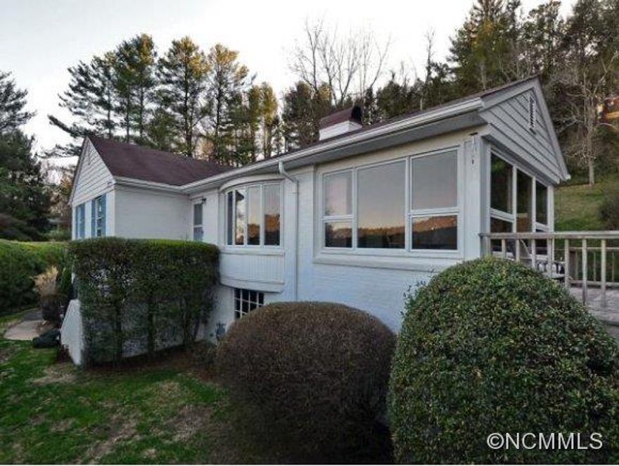 Prime location,views of mountains,Grove Park Inn,privacy and still walk to Merrimon! Gorgeous sunrm offers views&opens to deck w/views. Charm of this 1954 home includes smooth ceilings, arched doorways, heavy crown molding, fireplace,hardwoods and large cedar lined closet. Picture/bay window in LR+many other windows to maximize views.Full unfinished bsmt offers lg windows,heat&1/2 bath for future expansion.Landscape includes stonewalls&magnol