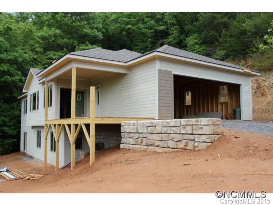 New construction. Low-maintenance Single-family home with flat driveway, spectacular year-round mountain views to the south and east, and a 5-minute drive to downtown Black Mountain. Master on main, open floorplan, wood-burning fireplace, luxury finishes. Great vacation rental potential. Public water and sewer. Photos are current as of 5-26-15. Buyer can still choose finishes, colors, etc. See MLS 557825 for sample of work. Taxes TBD.